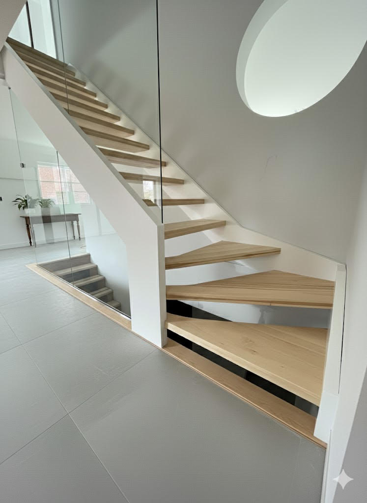 Escalier sur mesure au design architectural avec marches en bois clair et garde-corps en verre. Une intégration élégante et lumineuse pour un intérieur moderne.